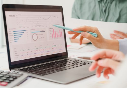 Closeup group of Asian business people meeting discuss project plan and financial results in office. Marketing strategy analysis, stock market trading, financial consultant concept.